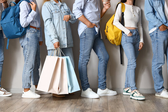 People Standing In Line Near Light Wall