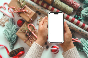 Phone with isolated screen on background of Christmas gifts