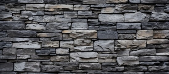 Fototapeta premium A background in shades of gray composed of a wall built with stones and bricks