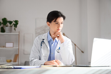 Female doctor video chatting with patient in office