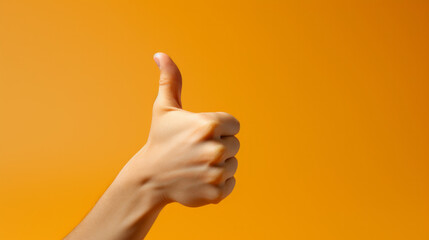 A hand giving a thumbs up sign on an orange background