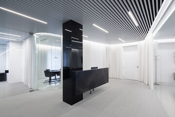 Spacious office with translucent partition and striped ceiling