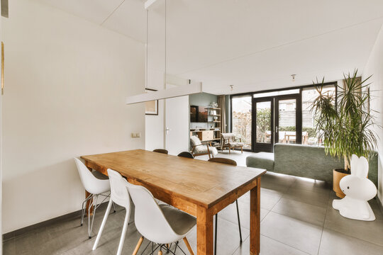 Dining room with wooden table and white chairs