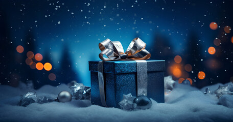 Fototapeta premium Blue gift on snow covered ground