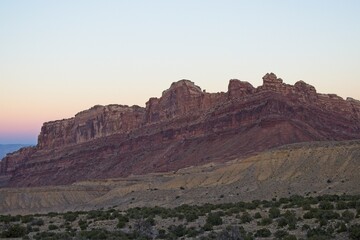 Interstate 70 winds through the San Rafael Swell, a high desert region of unique landforms like mesas and buttes and pastures on top