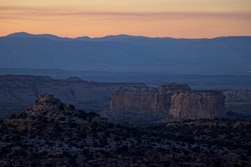 Interstate 70 winds through the San Rafael Swell, a high desert region of unique landforms like mesas and buttes and pastures on top