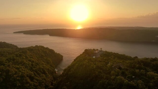 INDONESIA - AUGUST.9.2023 - Excellent aerial footage circling the sunset at the Amok mountaintop resort of Nusa Penida, Indonesia.