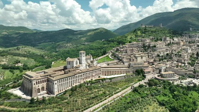 ITALY - AUGUST.9.2023 - Excellent aerial footage moving in towards the Basilica of Saint Francis of Assisi in Assisi, Italy.