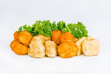 Assorted Breaded Chicken Inner Fillet,Chicken Breaded Raw Meat.Fast cooking.Breaded Chicken nuggets Fillet with salad on a White Background,food at home.Fast homemade food.Chicken breaded schnitzels.