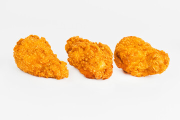 Semi-finished product, fried wings.Breaded Chicken wings with salad on a White Background,food at home.Fast homemade food.Chicken Breaded Raw Meat. Fast cooking.