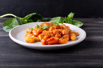 Gnocchi with tomato sauce, mozzarella cheese and basil. Italian traditional food.