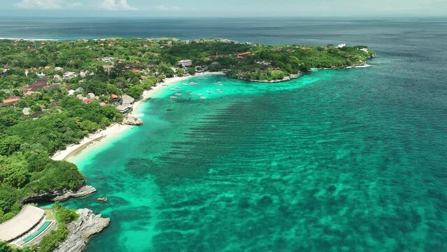 INDONESIA - AUGUST.9.2023 - Excellent aerial footage approaching boats in the harbor of a resort on Mushroom Bay, Nusa Lembongan, Indonesia.