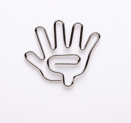 Macro shot of a hand shaped paper clips on white