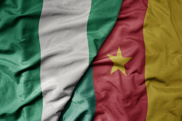 Obraz premium big waving national colorful flag of nigeria and national flag of cameroon .