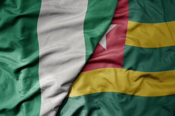 Obraz premium big waving national colorful flag of nigeria and national flag of togo .