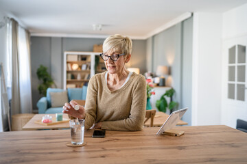 One senior caucasian woman take medicine drugs or supplement vitamin