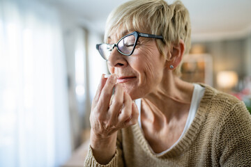 One senior caucasian woman take medicine drugs or supplement vitamin