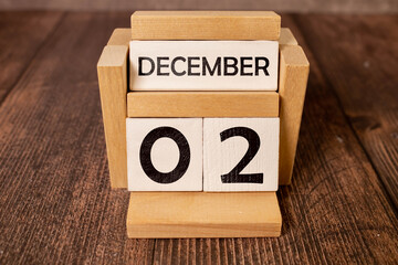December 2 text on wooden blocks with blurred nature background. Calendar concept.