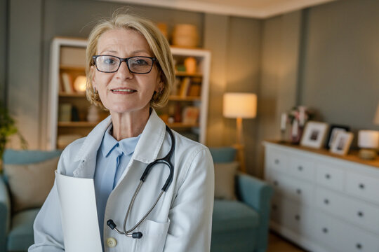 Portrait Of One Mature Blonde Caucasian Woman Doctor Medic Home Visit