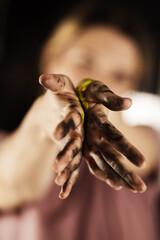 Female artist making an artistic painting with her hands. Girl mixing colors and painting hands.