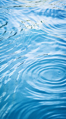 A blue water surface with ripples in the water