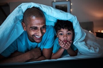 Night, streaming and father with child in a bed for movie, file or subscription entertainment in...