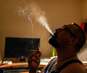 Handsome young man smoking cigarette