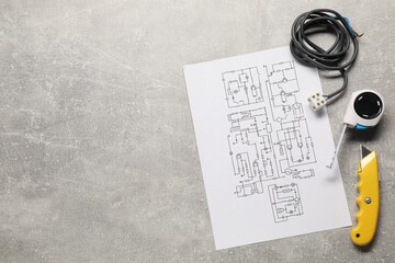 Wiring diagram, wires and tools on grey table, flat lay. Space for text