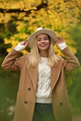 Portrait of happy woman in autumn park