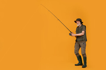Fisherman with fishing rod on yellow background, space for text
