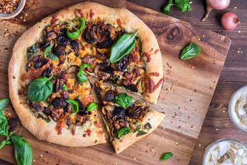 A homemade gourmet pizza topped with mushrooms and shallots.