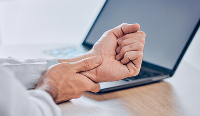 Man, hands and wrist pain from injury, accident or carpal tunnel syndrome on desk at office. Closeup of male person or employee with bad arm ache, sore muscle or tension and overworked at workplace