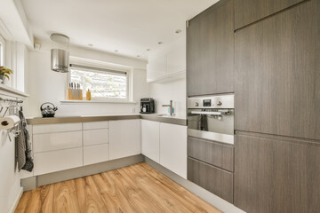 a modern kitchen with wood flooring and white appliances on the counter top in this room is very well organized
