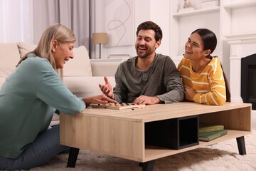 Family talking while playing checkers at home