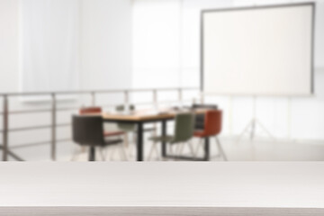 Empty white wooden table in comfortable office. Space for design
