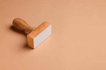 One wooden stamp tool on light brown background, space for text