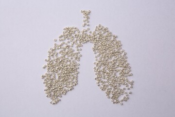 Human lungs made of beads on white background, flat lay