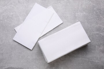 Clean tissue towels on light grey background, flat lay - obrazy, fototapety, plakaty