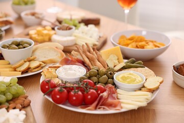 Assorted appetizers served on wooden table, closeup