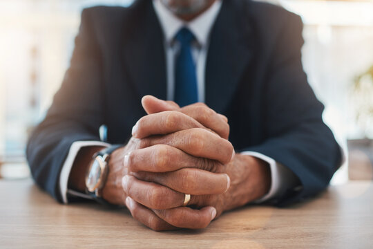 Hands, authority and lawyer man waiting while sitting at a table in court during a case or trial closeup. Justice, law and legal with a male advocate in a courtroom for representation or legislation