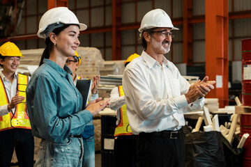 Happiness and joyful atmosphere, smiling factory worker and engineer celebrate with factory...