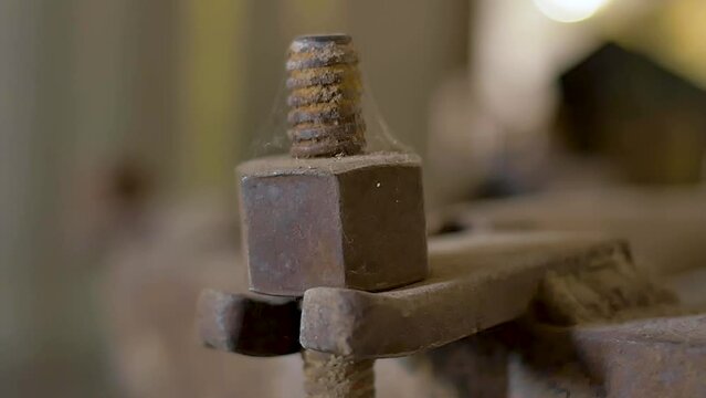 Rusted nut and bolt details of old wooden wine barrel, made of oak, seen on a close up, slow motion camera movement. Aged for decades on a wine house at a traditional winery 
