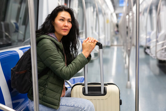 Portrait of young woman commuting in city using subway train