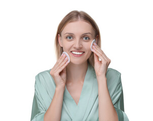 Fototapeta premium Young woman cleaning her face with cotton pads on white background