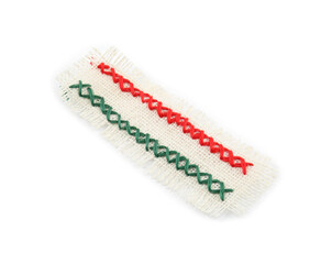 Piece of burlap fabric with cross stitches isolated on white