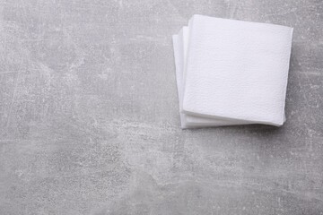 Stack of clean paper tissues on light grey background, top view. Space for text