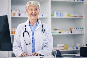 Happy, portrait and a pharmacist typing on a computer for medical information, email or working. Smile, pharmacy and a mature woman with a pc at a clinic or medicine store to check for stock