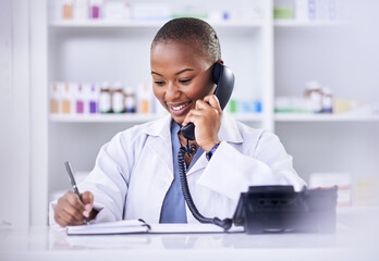 Black woman, phone call and pharmacist writing in notebook for Telehealth consultation at the pharmacy. Happy African female person, medical or healthcare professional talking on telephone at clinic - obrazy, fototapety, plakaty