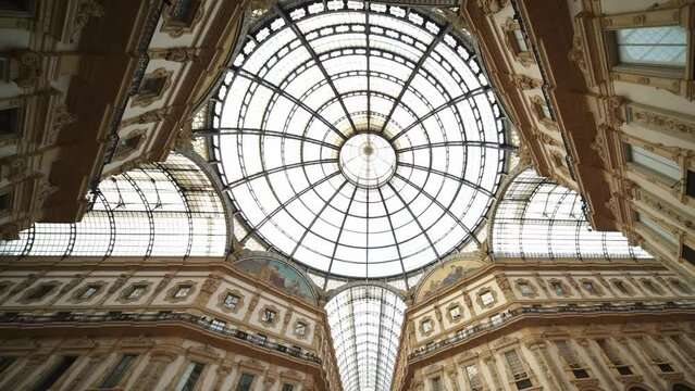 Ceiling dome in Galleria Vittorio Emanuele famous department store for high-end shopping in Milan. Popular fashion mall, tourist attraction in Italy.  