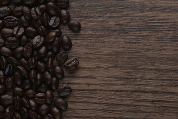 Roasted coffee bean on wooden table..